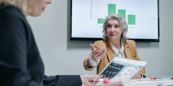 Business meeting discussing supply chain optimization strategies with charts