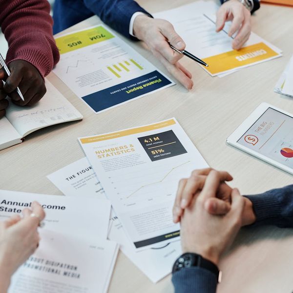 Professional analytics team reviewing transportation data on large display